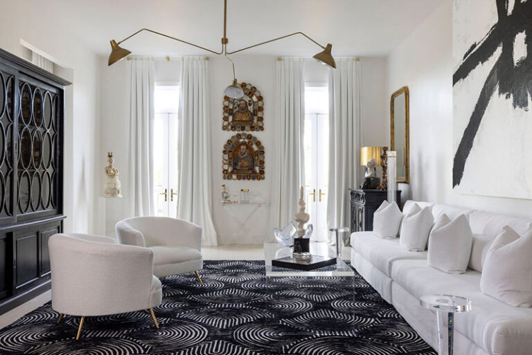 St. Charles Avenue condo living room with white seating, a black patterned rug and sculptural brass lighting